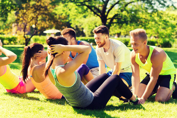 group of friends or sportsmen exercising outdoors