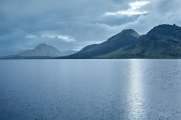 Lake coast with mountain reflection at the sunrise, Iceland