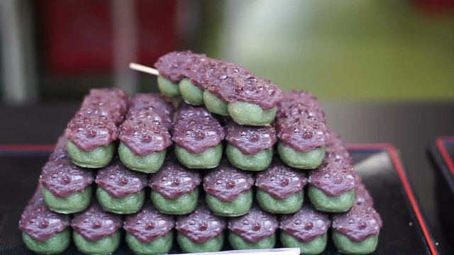 Japanese traditional dessert Dango, green tea with red bean and Mitarashi dango 