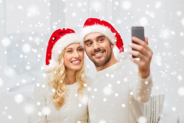 couple taking selfie with smartphone at christmas