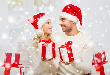 happy couple at home exchanging christmas gifts