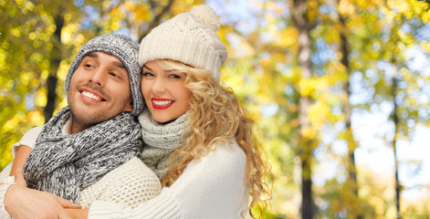 Fototapeta premium happy couple in warm clothes over autumn