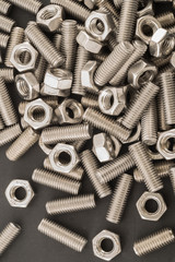 Closeup of Stainless steel nuts bolts and washers for industrial background