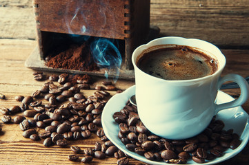 Steaming coffee with freshly ground beans. Top view. Copyspace