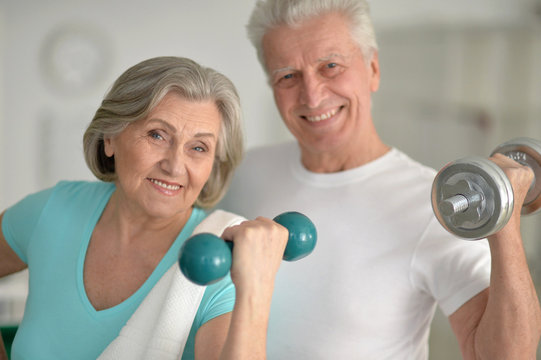 Senior Couple Exercising In Gym