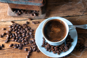 Cup of coffee with freshly ground beans. Top view. Copyspace