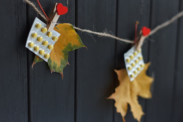 autumn leaves and pills on clothespins hanging