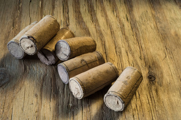 Wine bottle corks on the textured wooden background