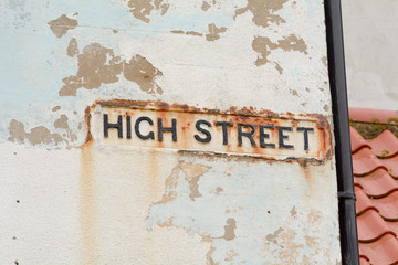 High Street sign on wall going rusty from sea water erosion