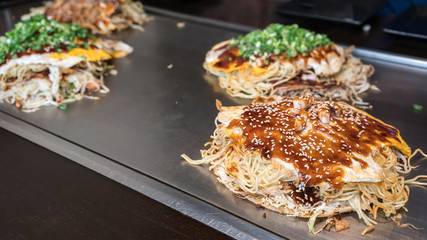 Hiroshima style Okonomiyaki or Japanese pizza serving in restaurant in Hiroshima , Japan