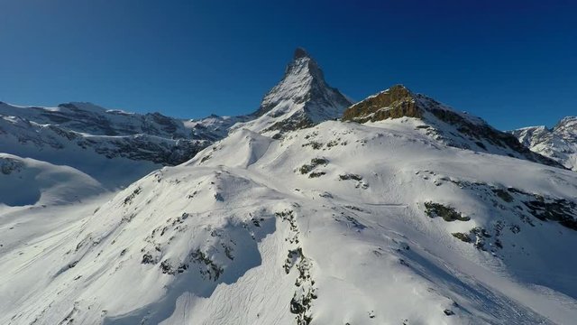 Aerial view of Matterhorn on a clear sunny winter day, Zermatt, Switzerland. Ski slopes of Downhill ski area Zermatt Matterhorn.
