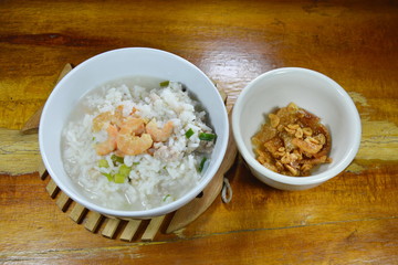 boiled rice minced pork and dried shrimp with fried garlic on bowl