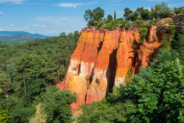 Reddish rock formations made of ocher near Rousillon village, Provence, France