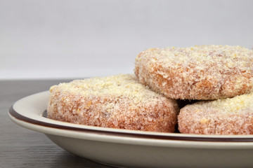 The raw patties made from minced meat before frying. White background.