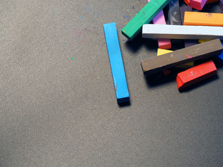 multicolored chalks on a dark background