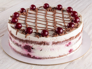 Chocolate cake with mousse, decorated cherries
