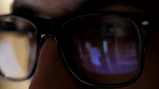 man watching erotic content on internet reflection on glasses