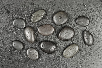 Black stones with water drops
