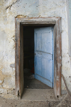 An old wooden door in a derelict building the village of Oblizza, Friuli, north east Italy.
