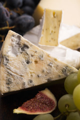 Assortment of cheese with fruits and grapes