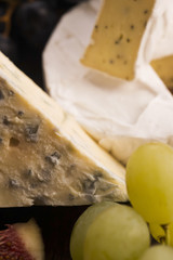 Assortment of cheese with fruits and grapes