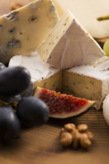 Assortment of cheese with fruits and grapes