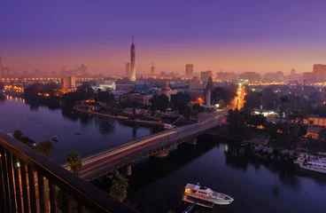 Wall murals Egypt CAIRO - EGYPT - DECEMBER 2010: panorama of Cairo and Nile, movement in morning, sunrise, view from top, with Cairo Tower, buildings, auto and boats.