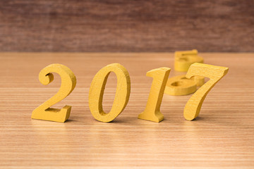 gold wooden font of year 2017 on wood table
