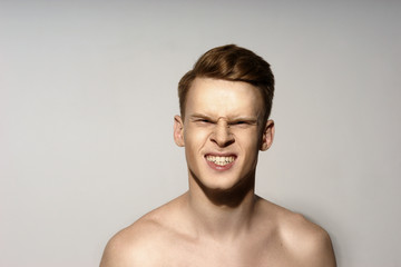 Fototapeta premium Fashion closeup portrait of young handsome red hair shouting with closed eyes