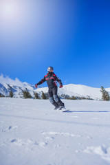 Fototapeta na wymiar extreme sport,snowboarder in action at the mountains