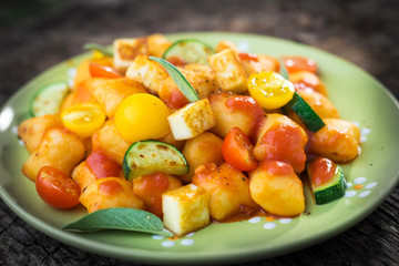 Homemade Italian gnocchi with tomato sauce and zucchini