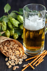 Bag of peanuts and mug of beer.