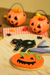 Creepy Halloween cookies next to a milk glass