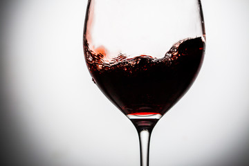 Naklejka na ściany i meble Stylish image of red wine splashing in glass