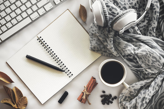 top view image of workspace. tablet computer, coffee and scarf background on white table. over light and vintage tone