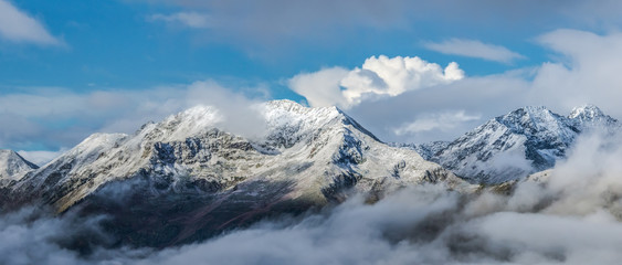 Fototapeta na wymiar First snow at tops of mountains. Greater Caucasus Mountain Range.