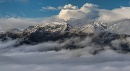 Snow mountain tops in clouds. Greater Caucasus Mountain Range.