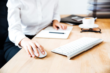 Cropped image of women's hands using keyboard and mouse