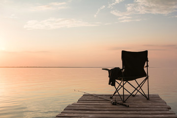 fisherman's chair over the lake at sunset