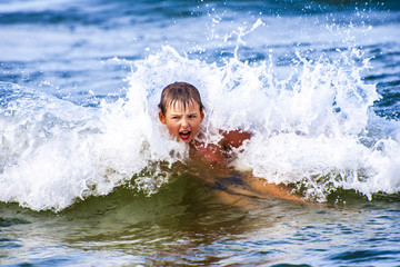 Young boy inside the wave. Poland, Baltic Sea.