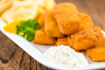 Fisch Sticks (close-up shot) on an old wooden table
