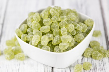 Wooden table with sour gummy candy