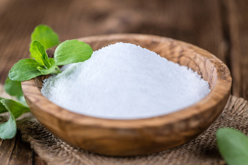 Old wooden table with Stevia Granules (selective focus)