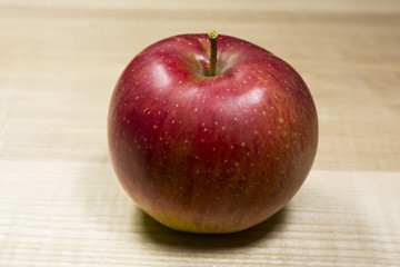 apple lying on a wooden surface