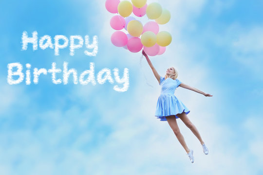 Happy Birthday text and beautiful young woman with colorful balloons against blue sky