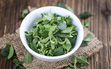 Wooden Table with fresh Menthol leaves