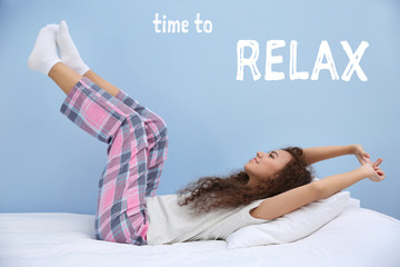 Beautiful young woman stretching after wake up. Text TIME TO RELAX on blue background.