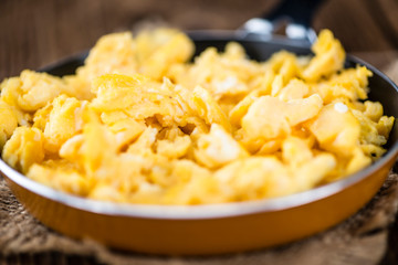 Scrambled Eggs (selective focus) on wooden background