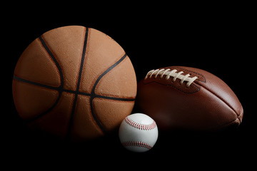 football,basketball,baseball on black background