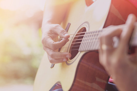 Young musician playing guitar , with fade effect